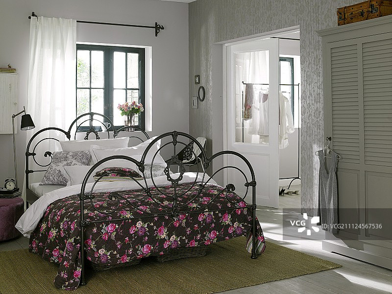 房间铁床上有玫瑰花格毯子图片素材