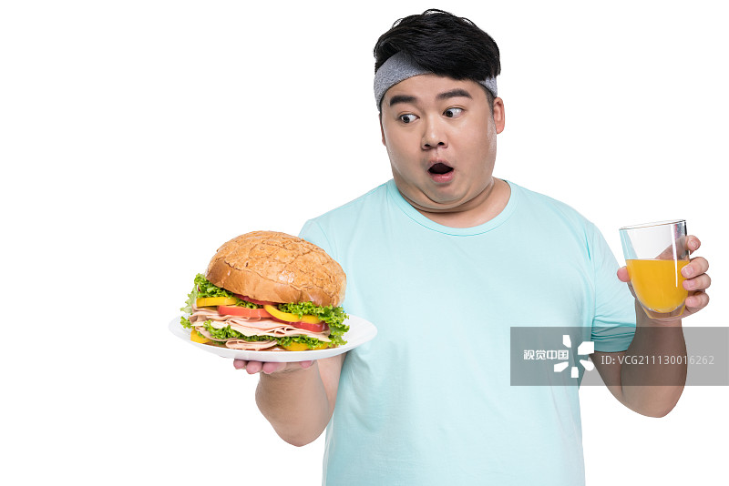 肥胖的年轻男子拿着汉堡和饮料图片素材