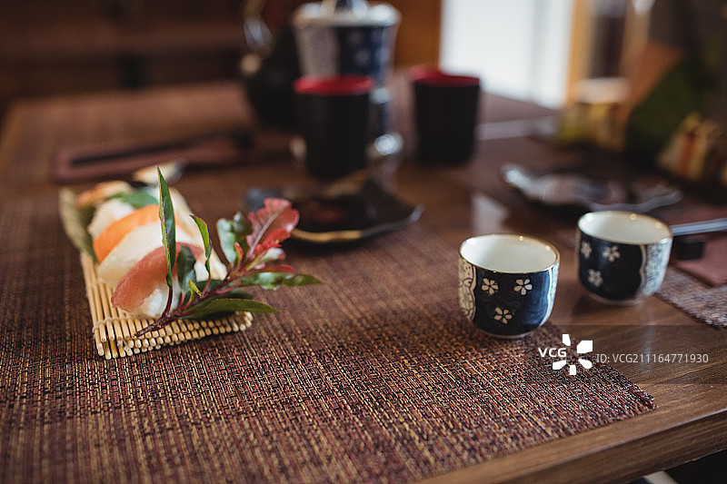 桌上放着寿司和一杯清酒图片素材