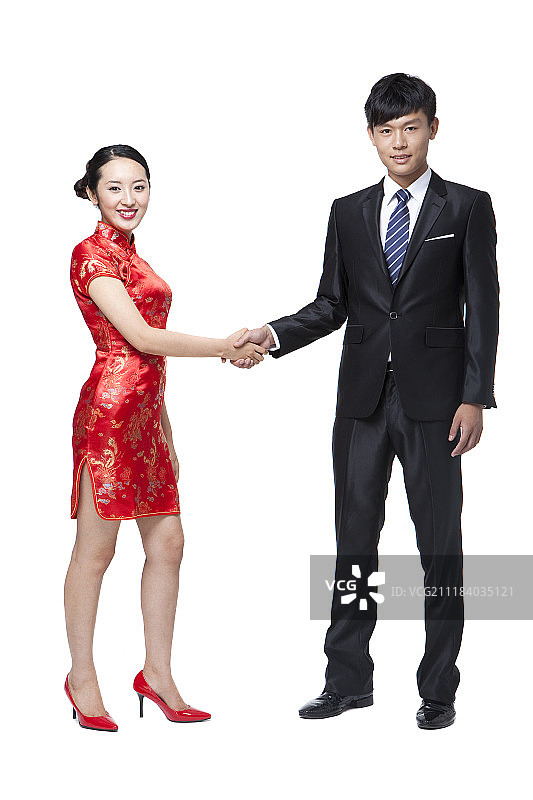 中国传统服饰女子与西装男子握手摄影图片素材