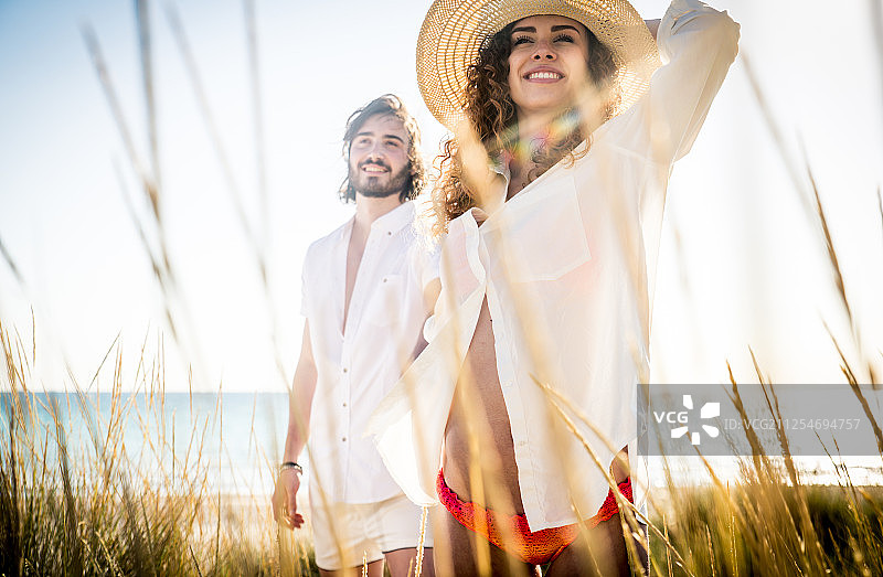 年轻夫妇分享快乐和爱的心情在海滩上图片素材