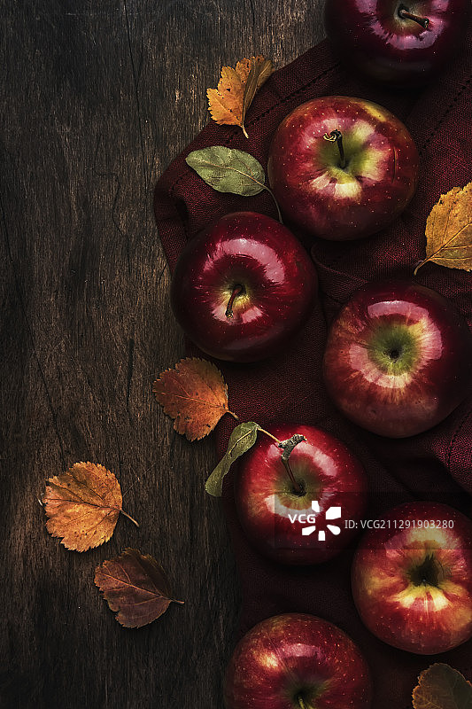 高角度的成熟苹果与落叶在乡村背景图片素材