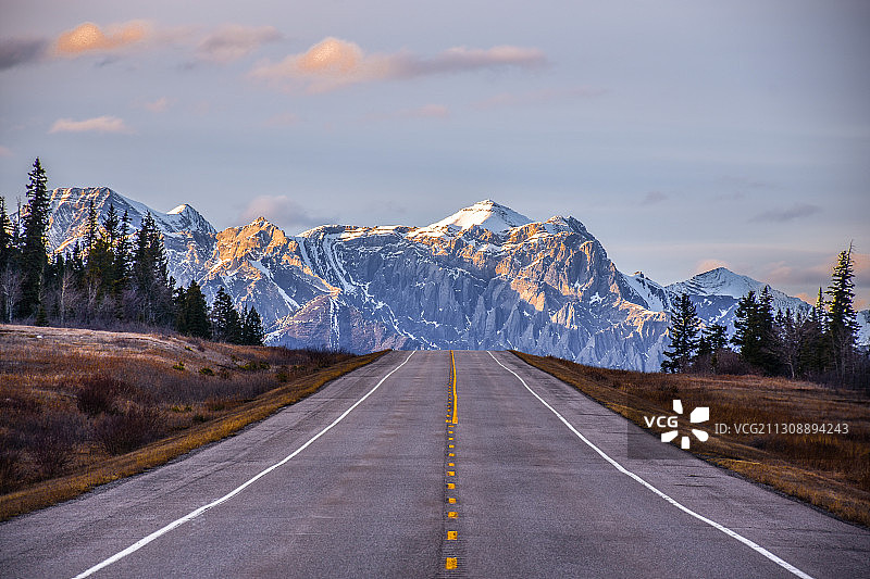 空荡的道路通向白雪皑皑的山峰图片素材