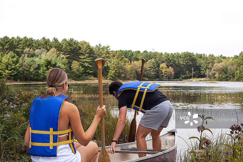加拿大安大略省联桥，两位白种人年轻人划独木舟，享受大自然图片素材