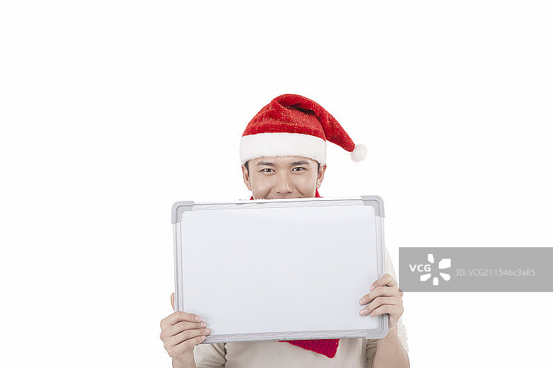 穿圣诞装的青年男子拿着白板图片素材