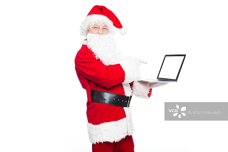 圣诞老人使用笔记本电脑图片素材