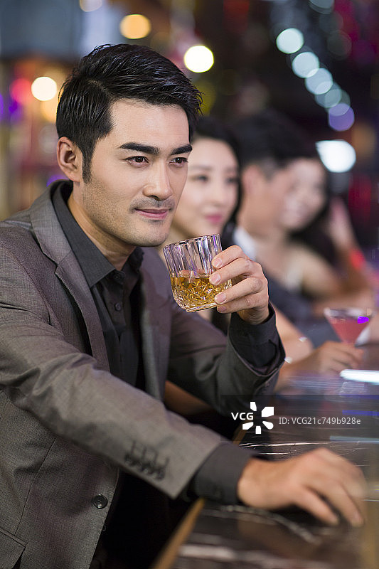 年轻男子在酒吧喝酒图片素材