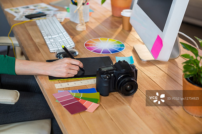 设计师在办公室中使用彩色轮和数字化仪图片素材