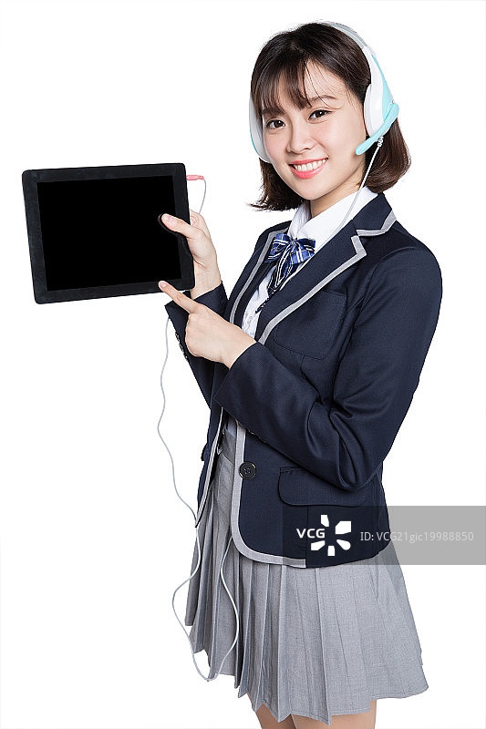 young student using digital tablet with headset图片素材