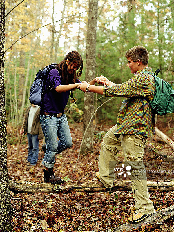 少年男孩和女孩(14-16岁)男孩帮助女孩徒步旅行图片素材