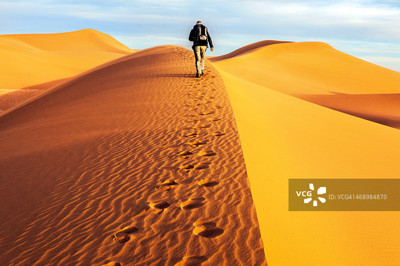 男游客走在沙丘上，早晨，米德，摩洛哥图片素材
