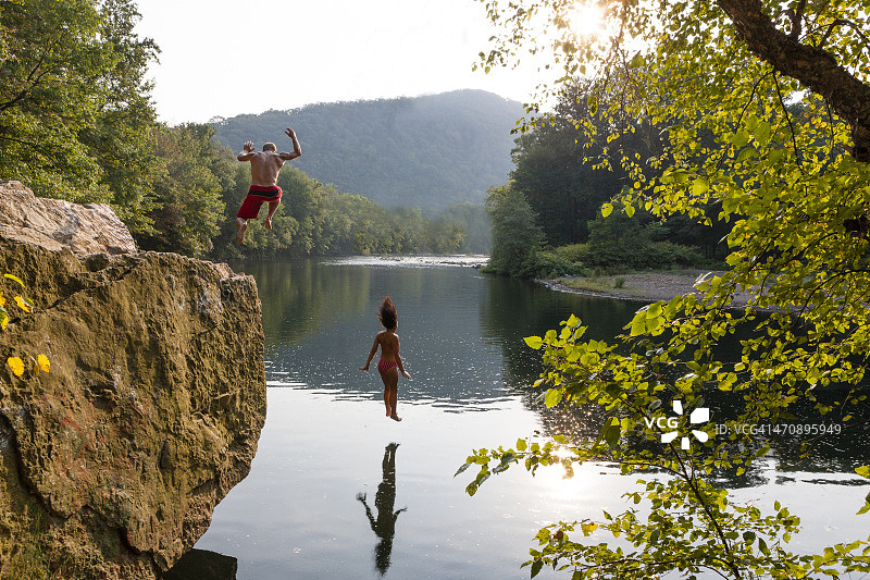 年轻夫妇从岩石上跳下，汉堡，宾夕法尼亚州，美国图片素材