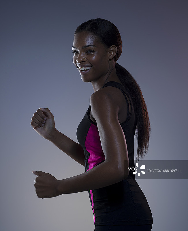 微笑的深色皮肤的女性锻炼图片素材