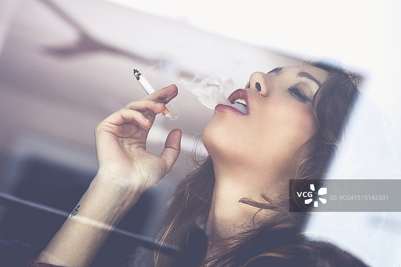 年轻女子吸烟放松图片素材