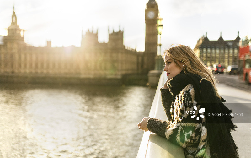 英国，伦敦，年轻女子在威斯敏斯特桥上图片素材