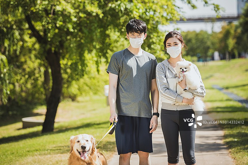 戴着口罩的夫妇带着狗狗图片素材