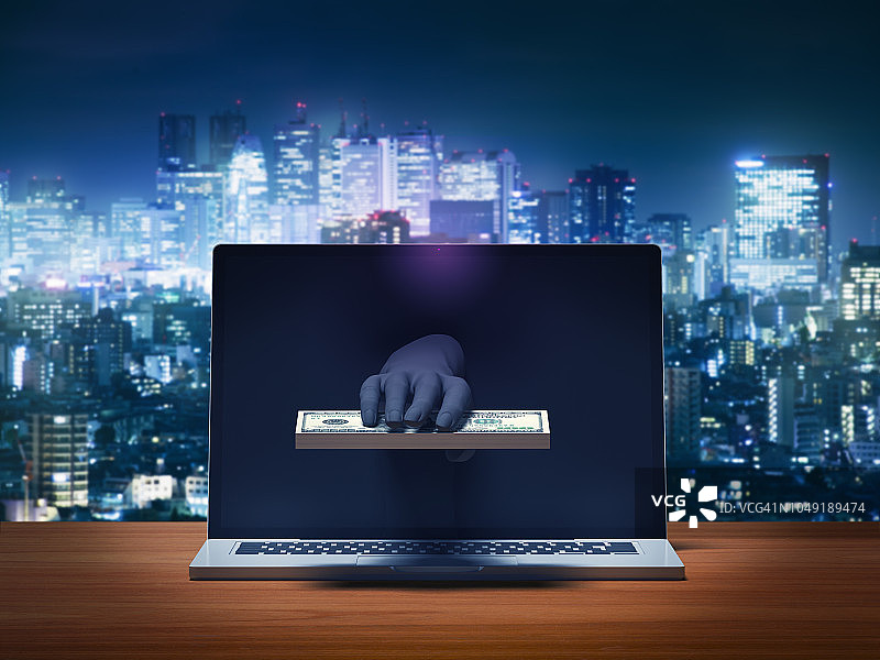 黑客的手从笔记本电脑显示器上偷钱图片素材
