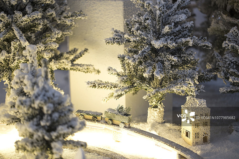 雪白的村庄，白色的圣诞节和木制的房子。微型圣诞树上的雪花和装饰品。图片素材