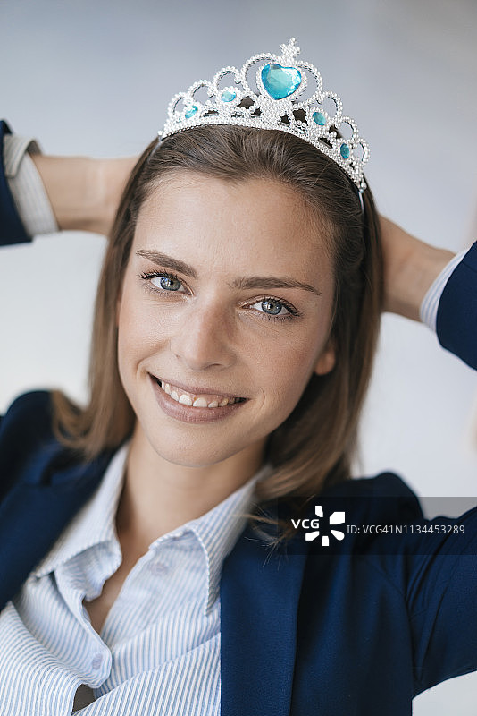 野心勃勃的年轻女子戴着皇冠作为对她成就的奖励图片素材