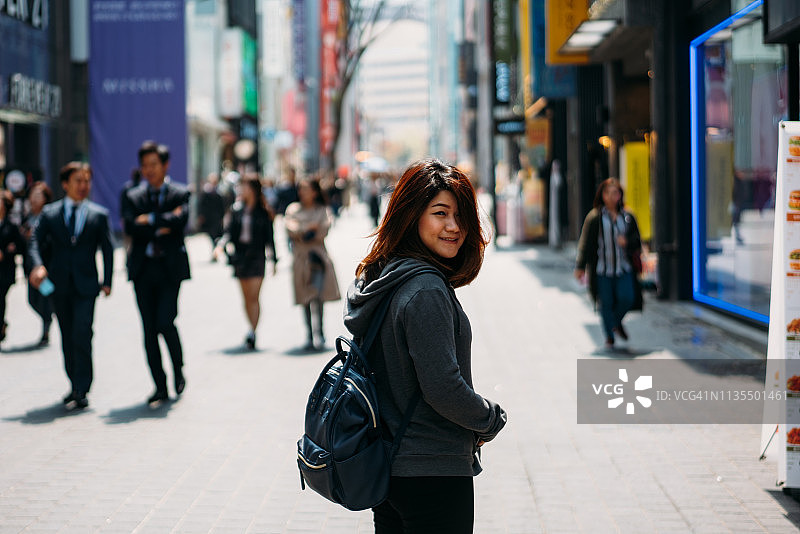 年轻的亚洲女性旅行者旅行和购物在明洞街市场图片素材