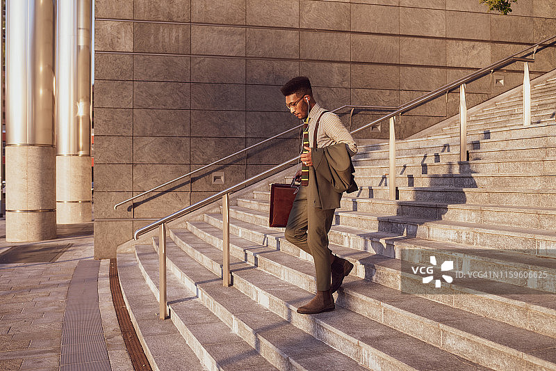 意大利伦巴第米兰，商人从办公楼的楼梯上下来图片素材