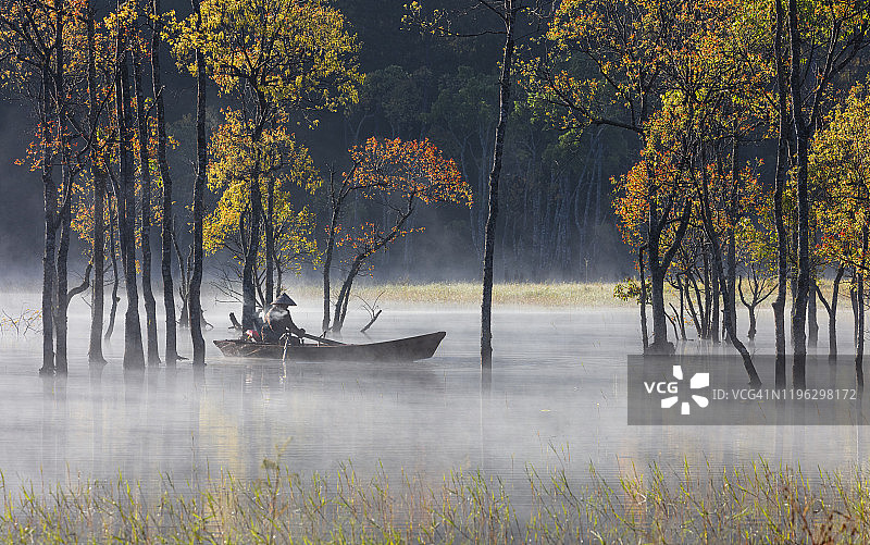 湖上秋雾林里的无名垂钓者图片素材
