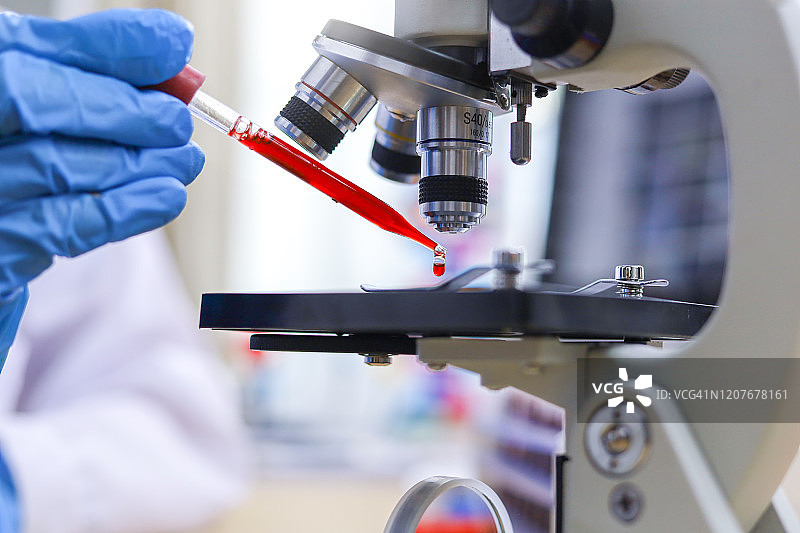 科学家在实验室分析血液样本，亚洲科学家在样本疾病实验室工作图片素材