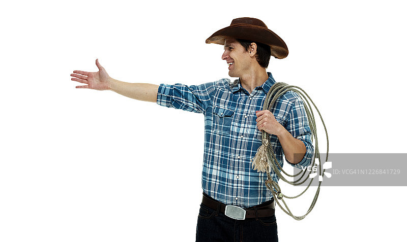 白人年轻男性牛仔戴着帽子，手持套索，用绳子站在白色背景前图片素材
