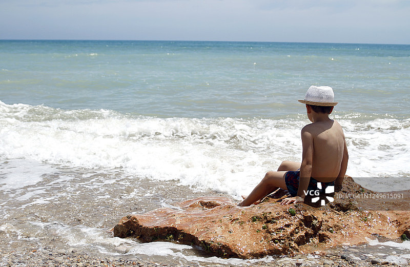 男孩享受大海的后视图图片素材