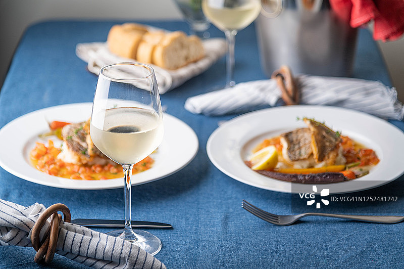 奢华的法式餐厅形象，鲈鱼配白葡萄酒图片素材
