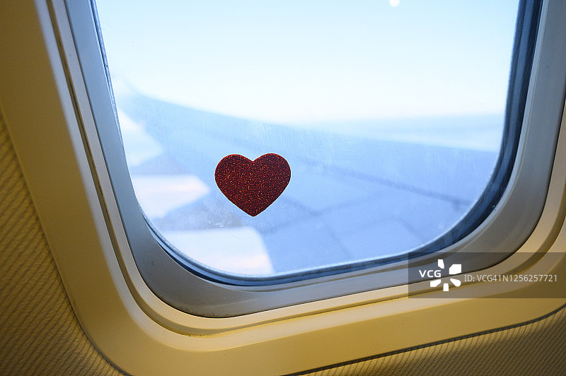 一架飞机窗户上的心形。图片素材