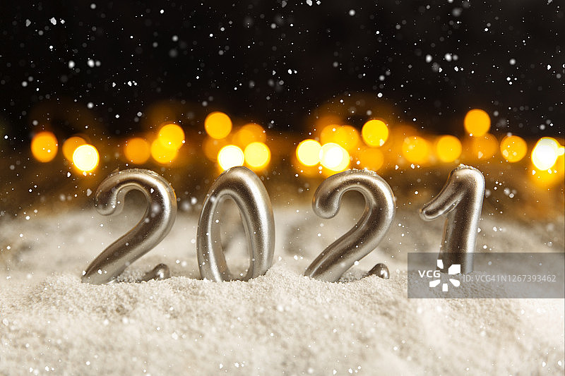 新年快乐的节日背景与银色数字2021和圣诞装饰在古董木制桌顶视图。图片素材