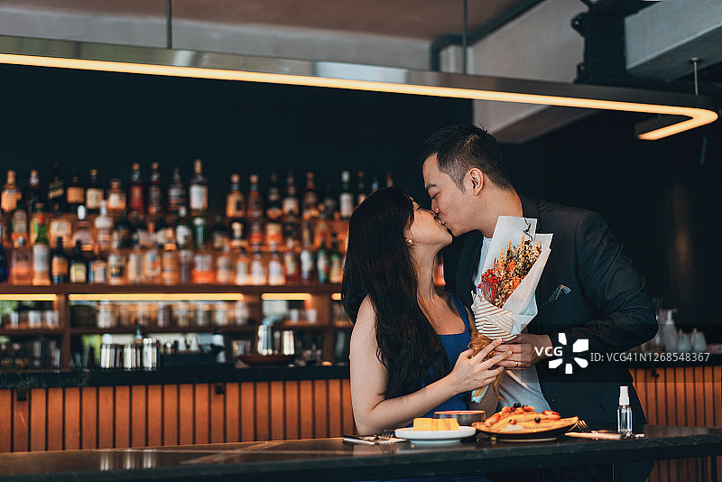 在餐馆里庆祝结婚纪念日或情人节的亚洲夫妇图片素材