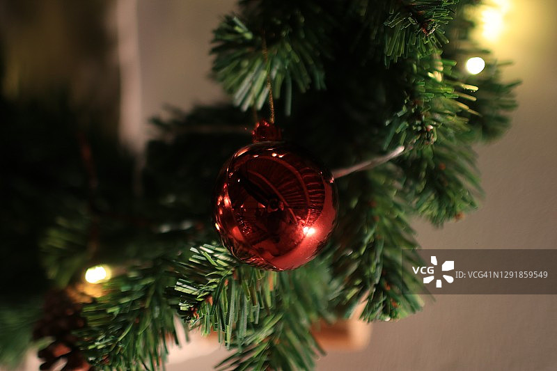美丽的红色装饰品装饰在圣诞树上。圣诞节和新年假期的背景。图片素材