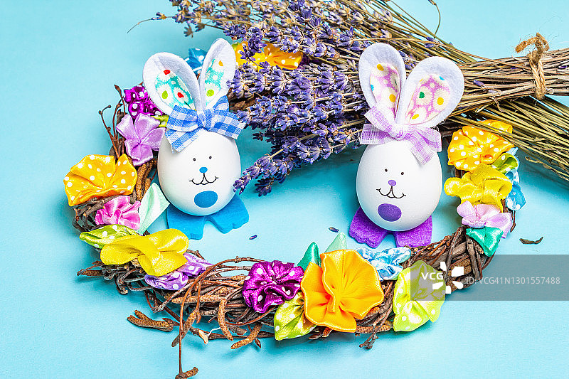 传统的复活节符号概念。用鸡蛋自制的可爱兔子，柳条花环，温和的郁金香图片素材
