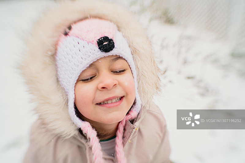 小女孩在雪中笑得很开心图片素材