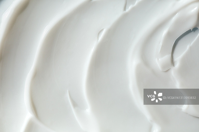 白色酸奶或奶油涂抹的纹理。为你的设计提供良好的背景图片素材