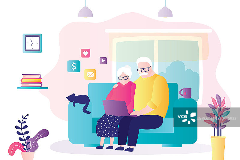 一对老夫妇坐在沙发上使用电脑。奶奶和爷爷在网上聊天和购物图片素材