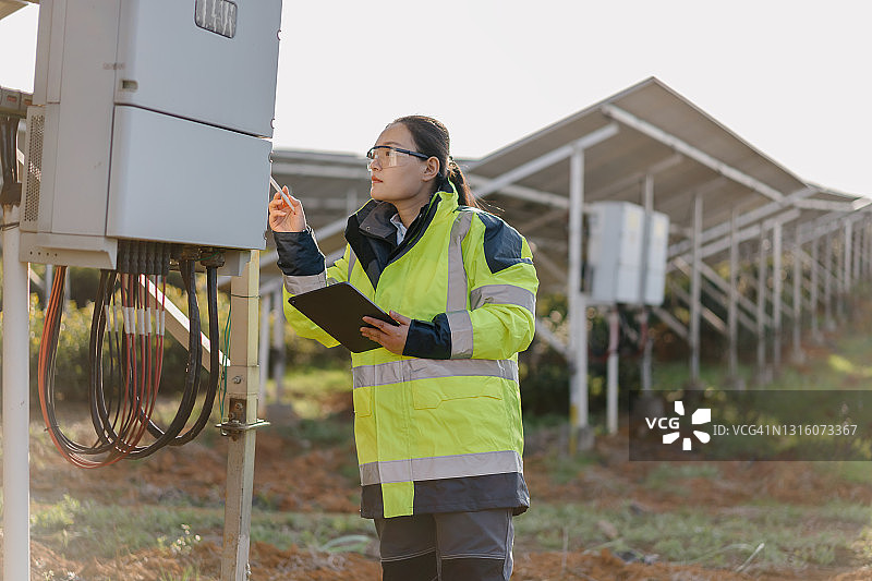 在太阳能电站工作的亚洲女工程师图片素材