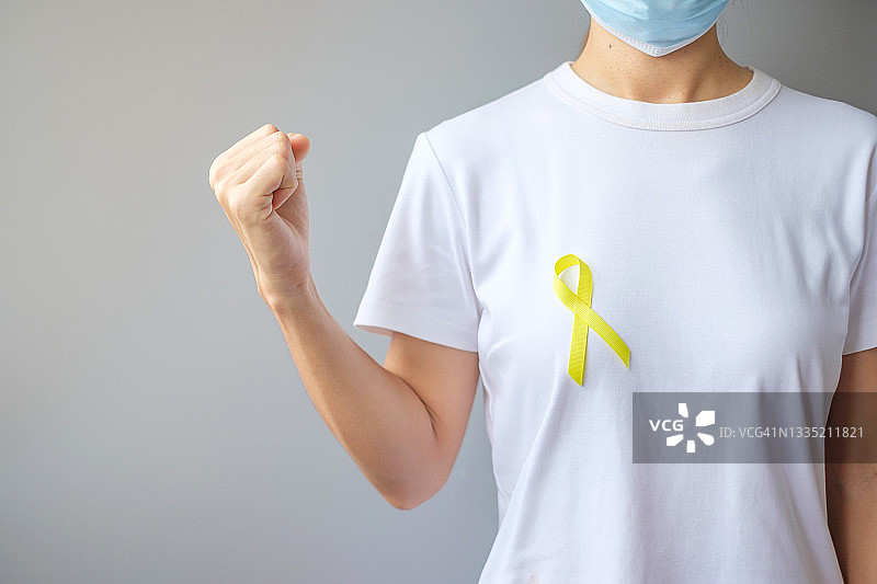 黄丝带，用于支持人们的生活和疾病。九月预防自杀日，儿童，肉瘤和骨癌宣传月概念图片素材