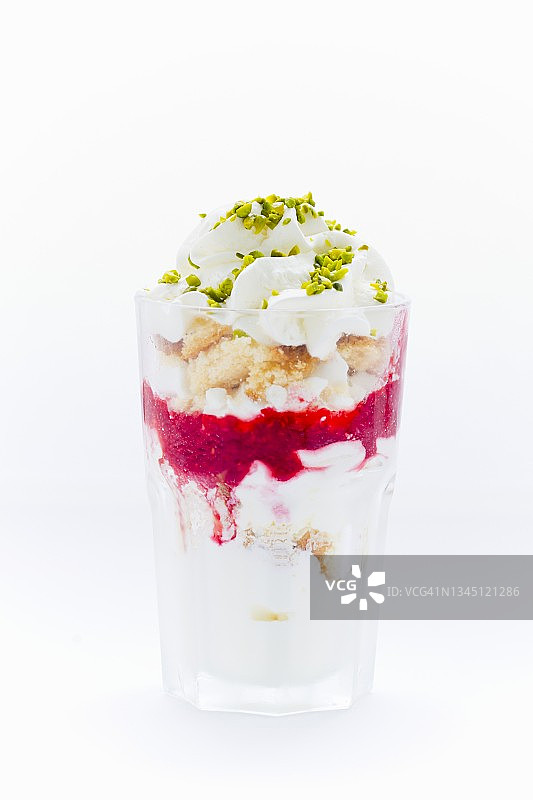 冷冻酸奶香草蛋糕，蛋白霜，覆盆子purée，开心果和奶油图片素材