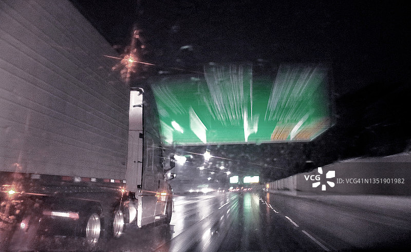 半卡车在夜间高速公路上，移动模糊图片素材