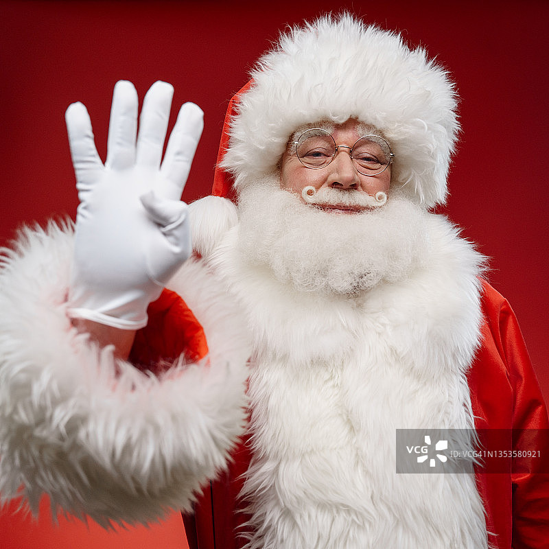 红色背景上的圣诞老人正在倒计时迎接新年的到来图片素材