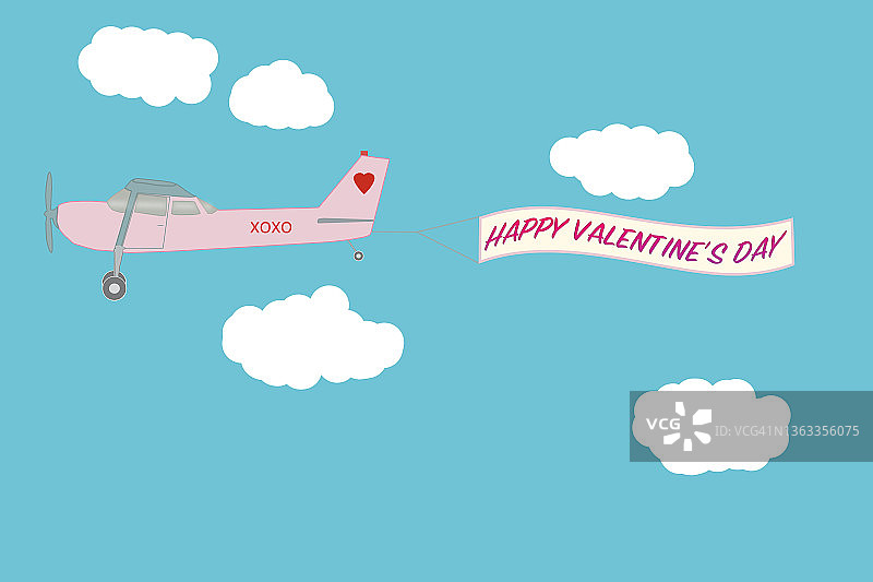 一架粉红色的塞斯纳飞机拖着一张情人节快乐的横幅图片素材