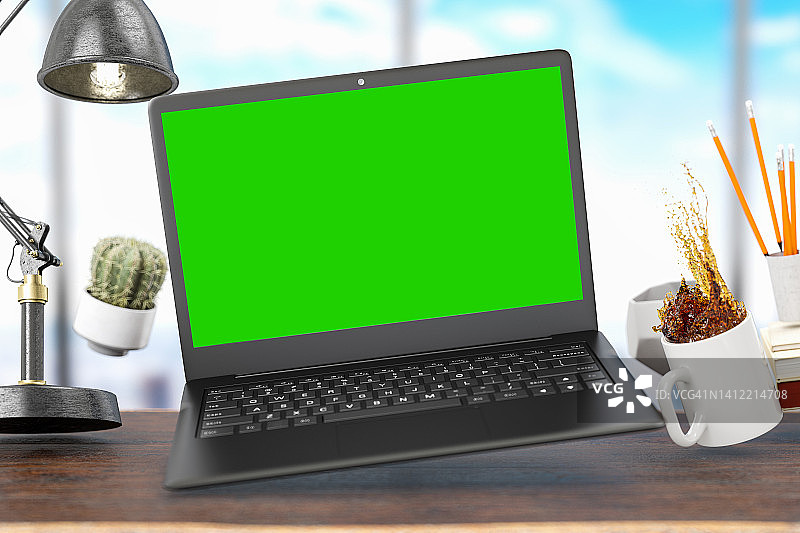 绿色屏幕的笔记本电脑和漂浮在空中的办公工具。零重力的概念图片素材