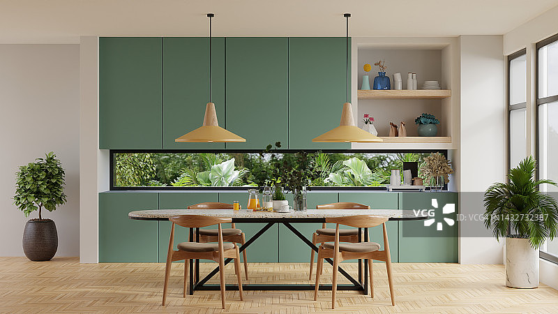舒适的现代厨房室内设计与墨绿色的墙壁。图片素材
