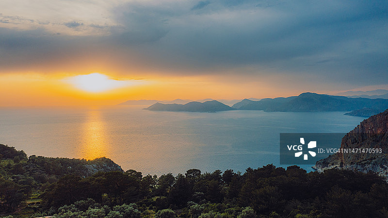 在土耳其Oludeniz的水晶蓝色的大海和岛屿上，戏剧性的日落鸟瞰图图片素材
