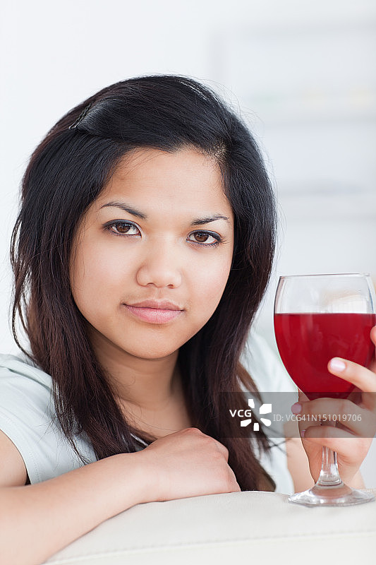 一个女人拿着一杯酒的特写图片素材