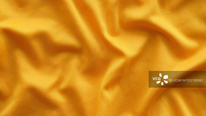 光滑优雅的金色聚酯织物纹理织物背景。关闭了。图片素材