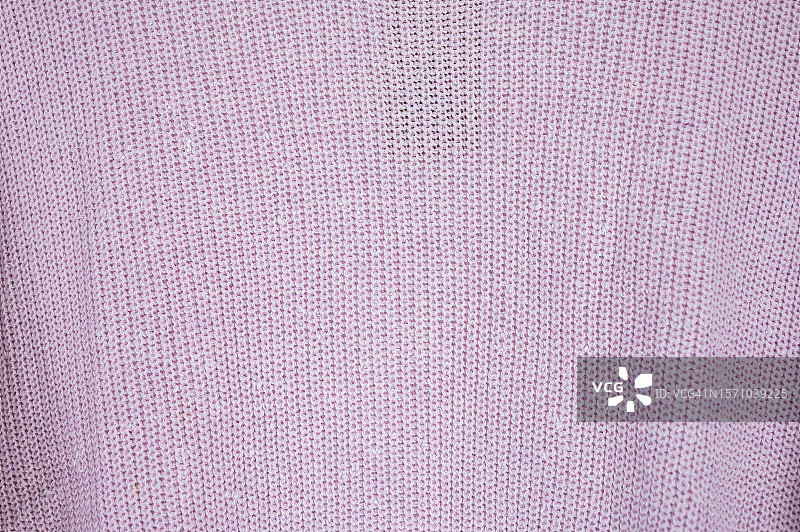 粉红色的织物纹理背景。图片素材